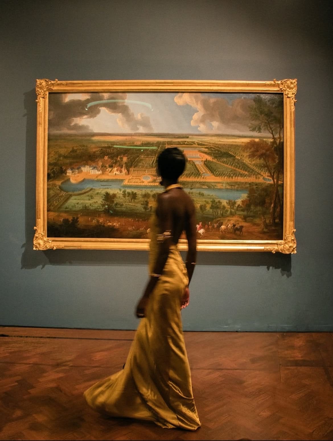 Gallery visitor viewing a framed landscape
